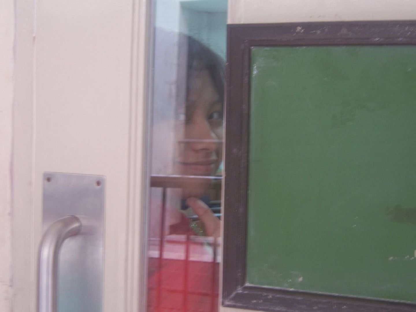 It's Icka reflection against the door, just as she finishes her International Studies exam.