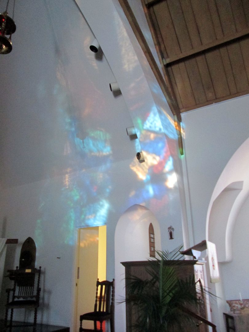 stained glass window reflection on chancel wall