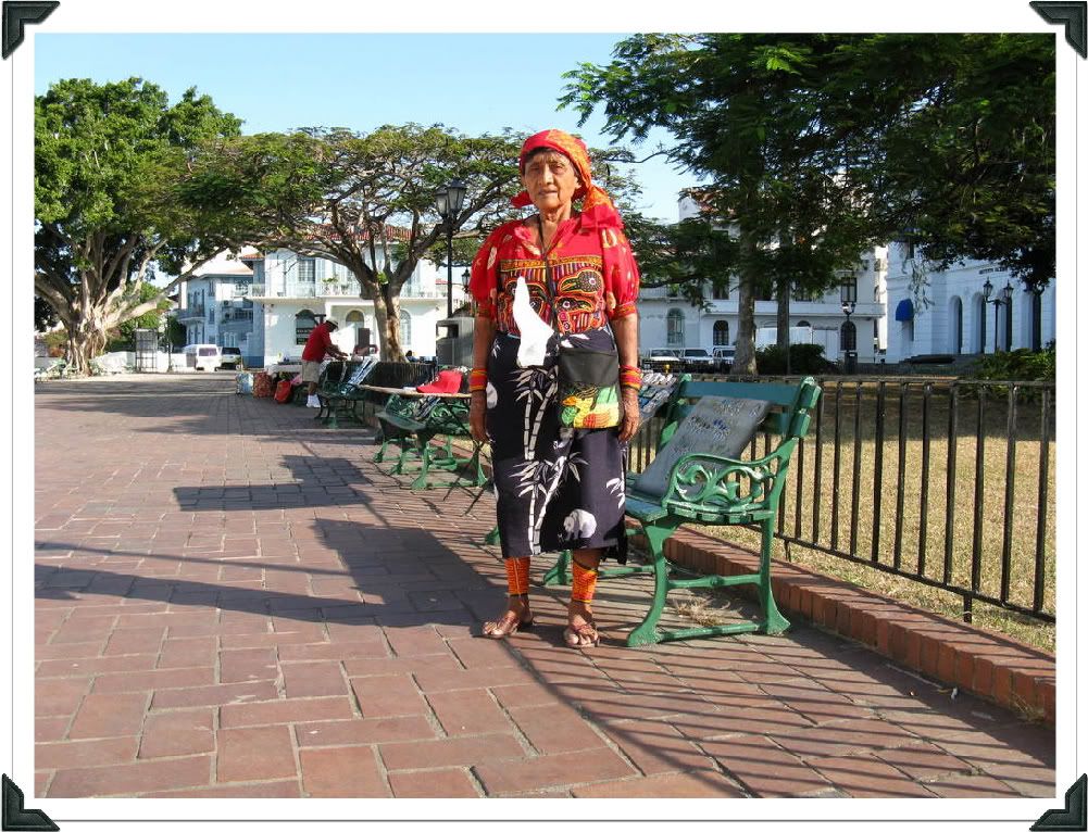 Photograph of a Kuna lady wearing the typical Kuna mola and the rest of their traditional attire. As you can see, she is not very happy at having her picture taken.