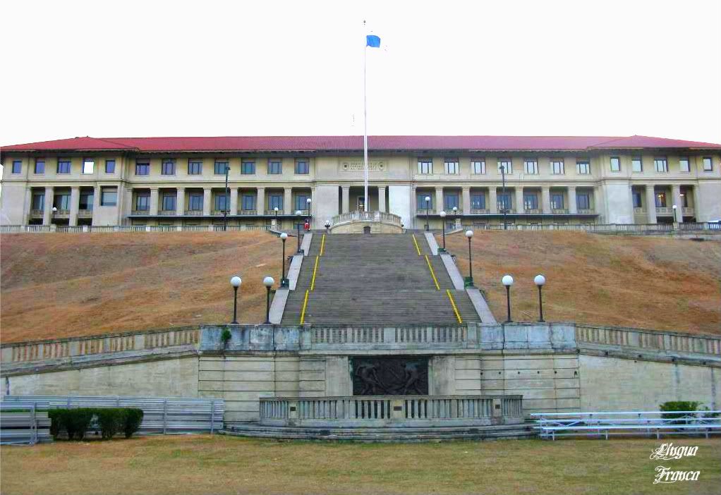 A front view of the Administration building with the Panama flag waving in the middle of the scene. Notice the long concrete stairway leading up to the building. (Credit: Omar Upegui R.)
