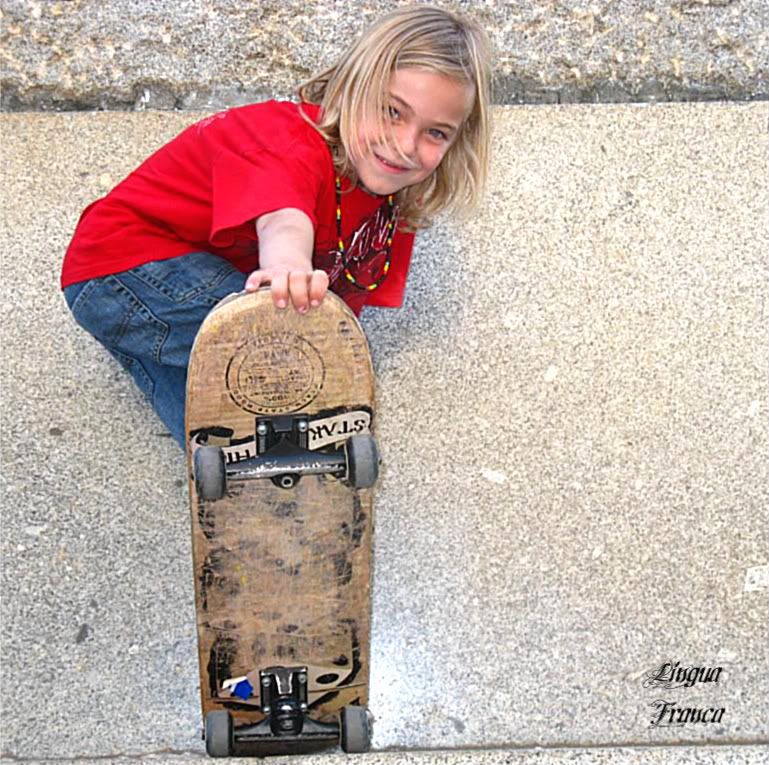 Beautiful photograph of Nicolas proudly displaying his skateboard. His face is so sweet as children can be. (Credit: Omar Upegui R.)