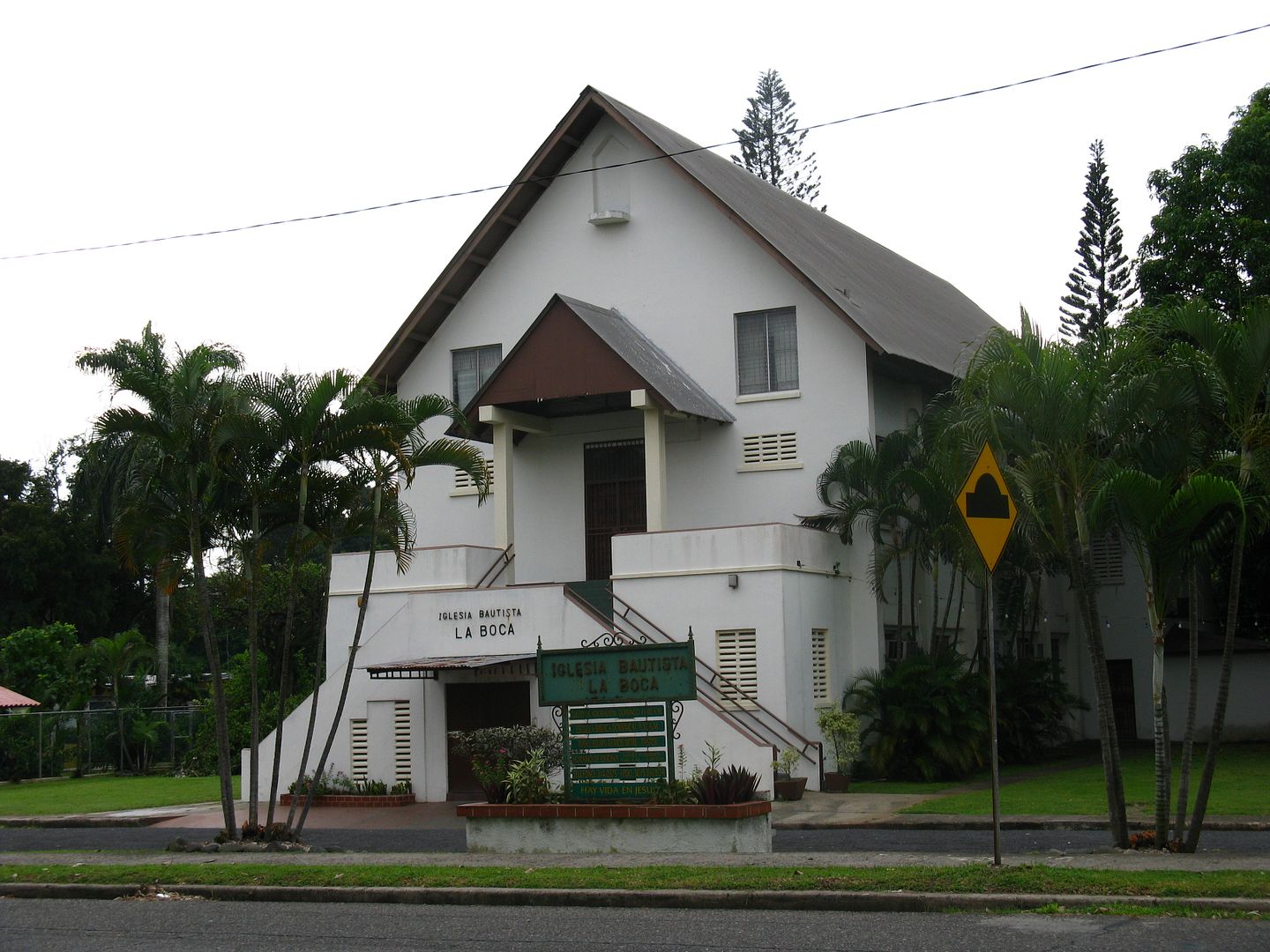 Photograph of the La Boca Baptist Church located at the entrance of the Panama Canal 3 miles downstream. Notice the tall elegant pine trees in the background. (Credit: Omar Upegui R.)