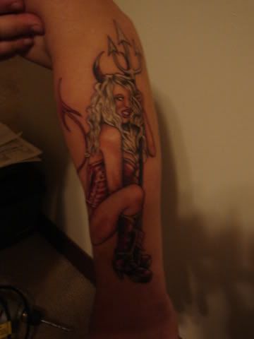 "veritas" (truth) will be on the devil girl arm.